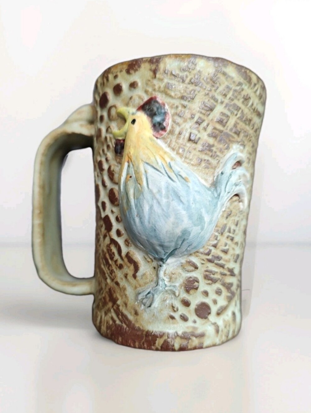 Small Artsy Handcrafted 3-D Rooster Relief Ceramic Mug Blue, Brown, Creamy Yelow